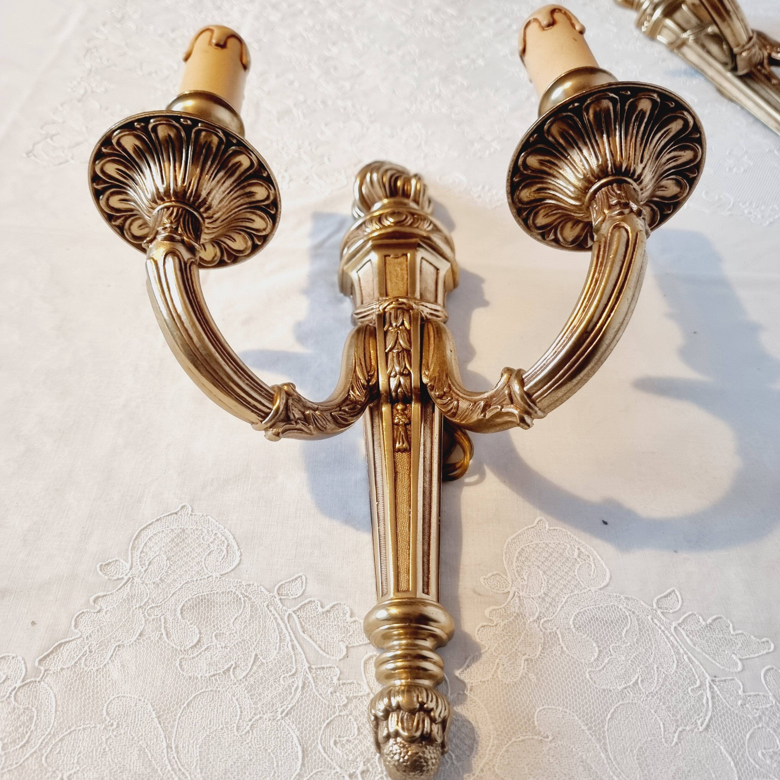 Pair of Louis XV style rocaille two-armed sconces in gilded bronze