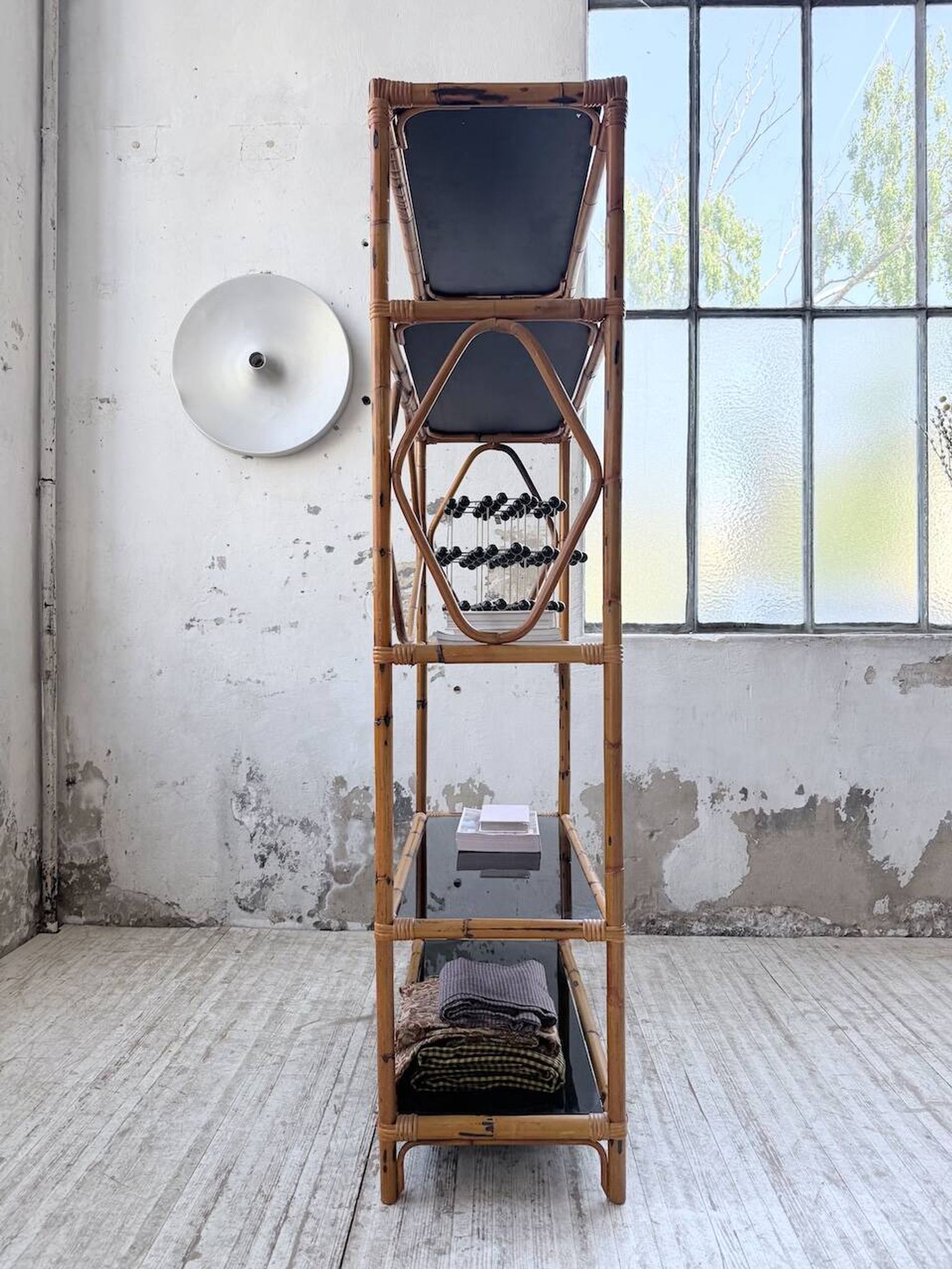 Rattan bookshelf and black glasses