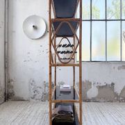 Rattan bookshelf and black glasses