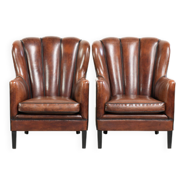 Set of 2 sheepskin armchairs with black piping and deep colours