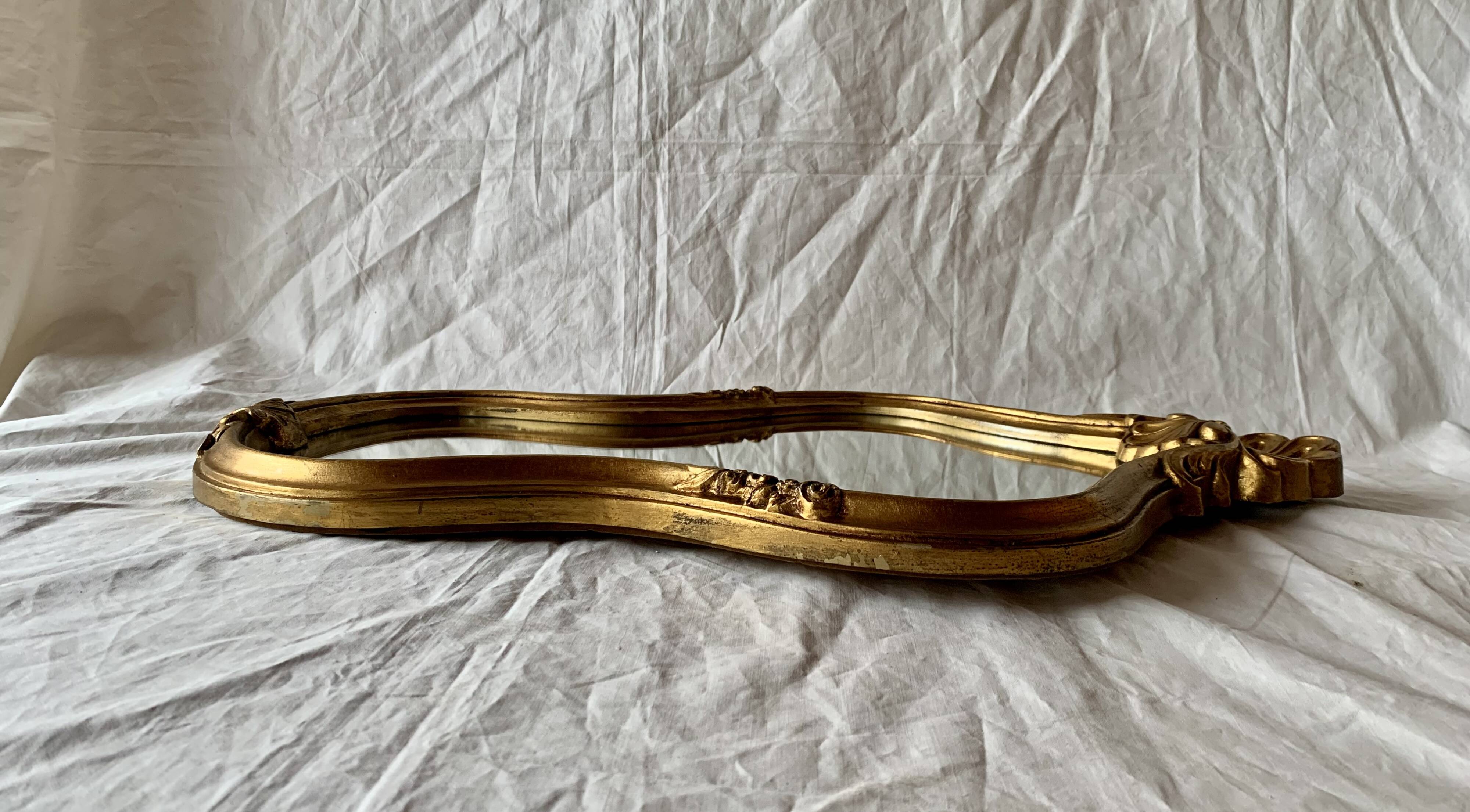 Large rococo mirror in gilded wood