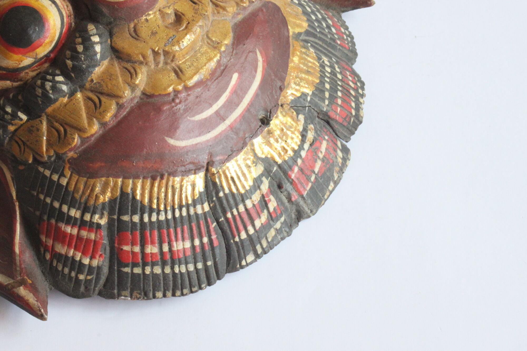 Two polychrome painted and gold leaf gilded Barong dance masks from Bali, Indonesia.