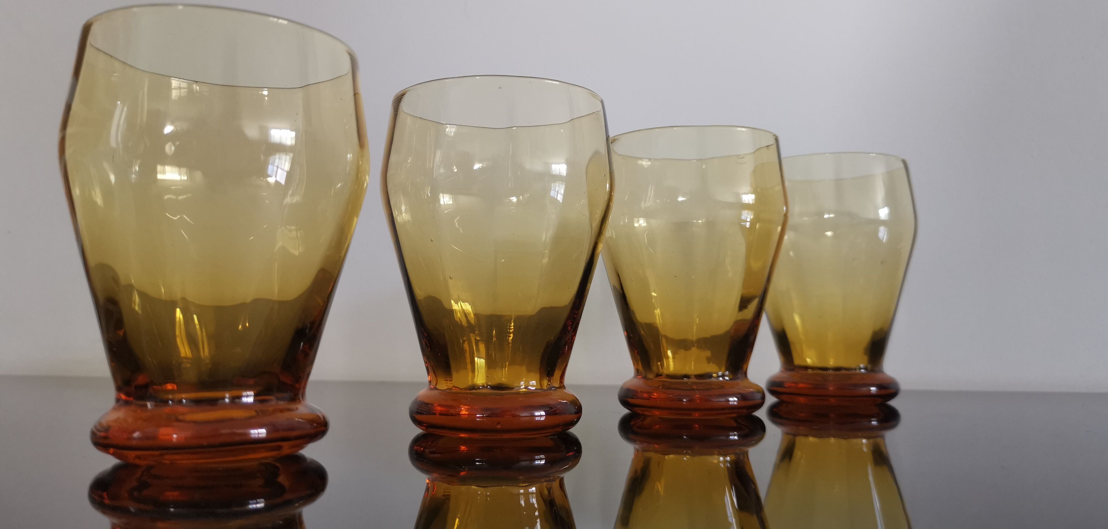 4 old amber colored glasses