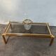 Gold metal coffee table with elm burl imitation.