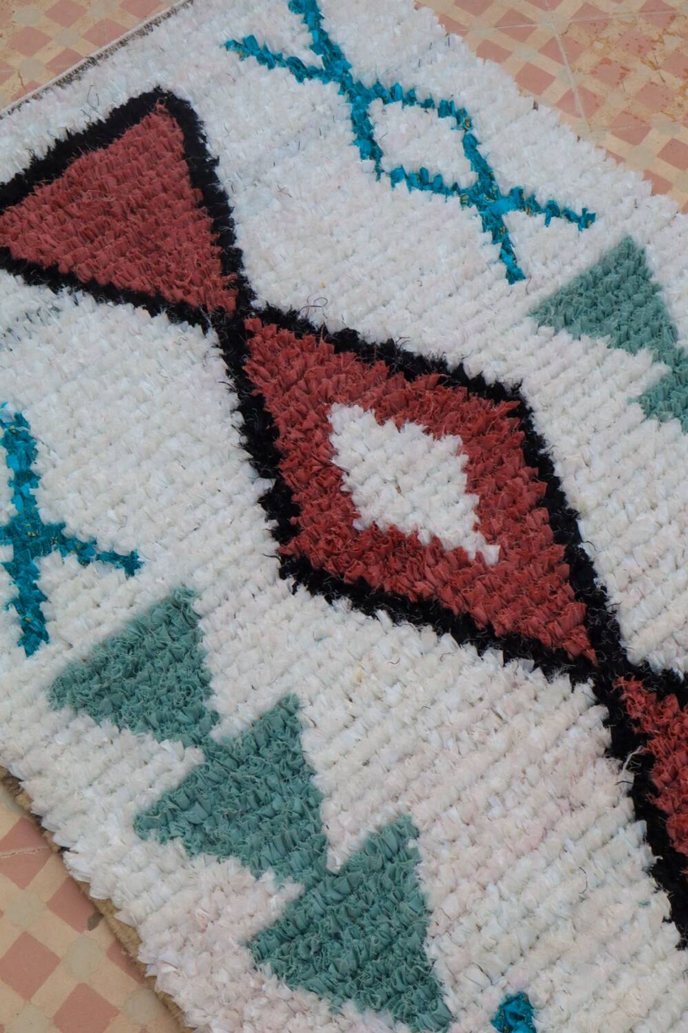 White Moroccan Boucherouite Berber rug with colorful patterns