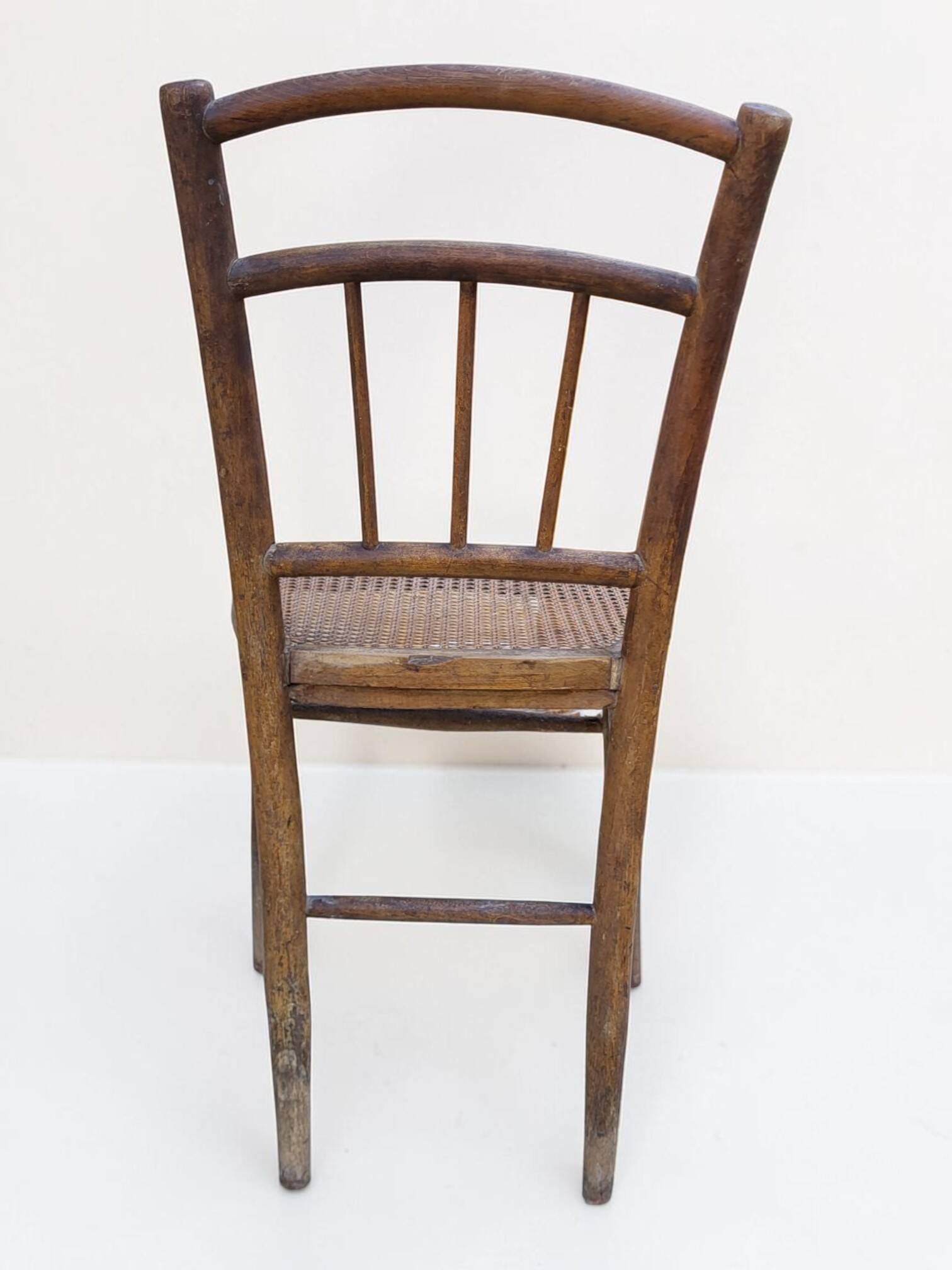 Chair with a slatted backrest and caned seat.
