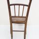 Chair with a slatted backrest and caned seat.