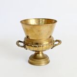 Vintage brass cache-pot on a stand with handles, classic decor.