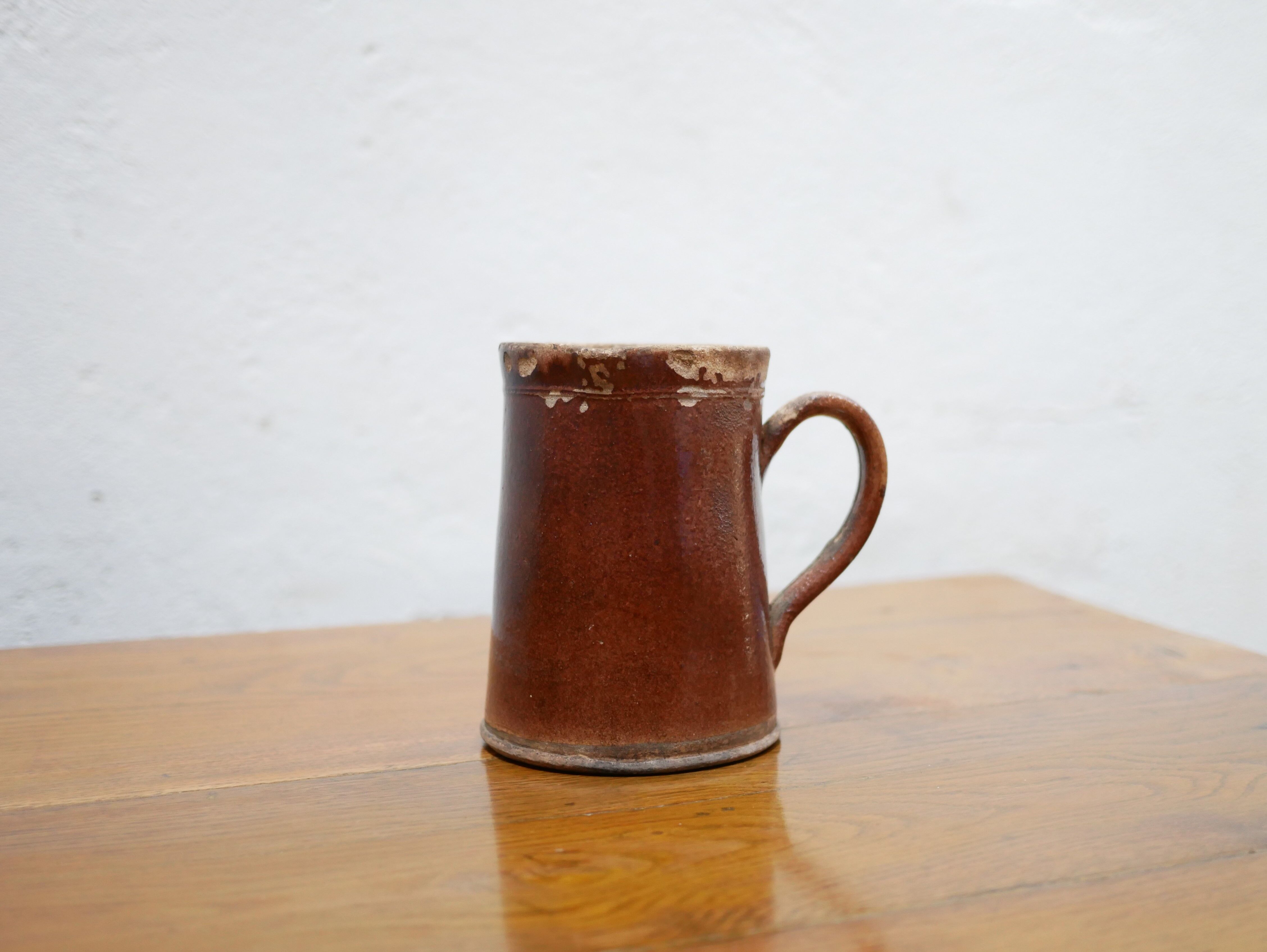 Vintage pitcher in glazed terracotta