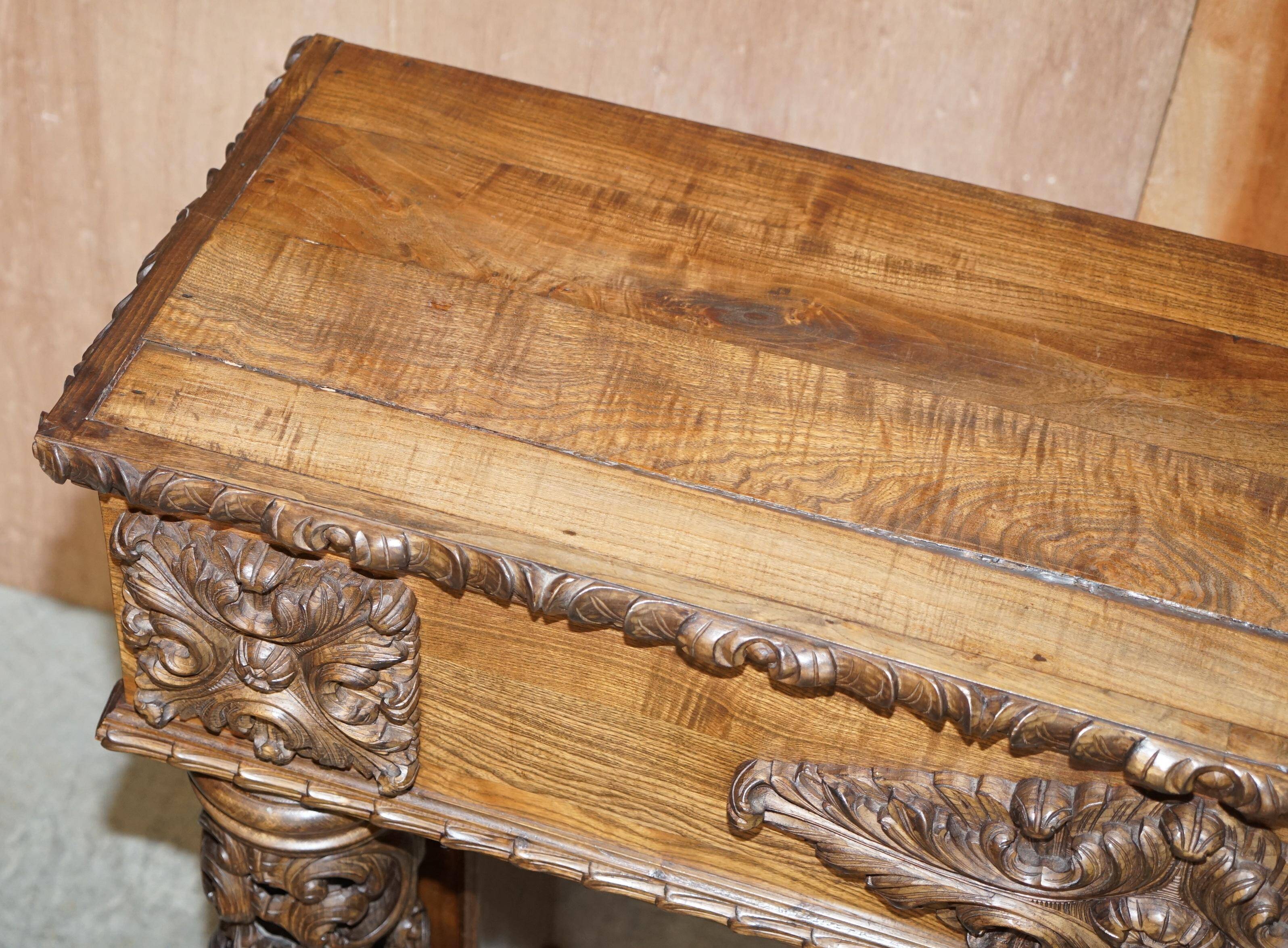 Antique fireplace from around 1880 in solid hand-carved elm with openwork columns.