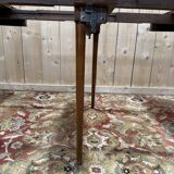 Round dining table with leather top in Louis XVI style.