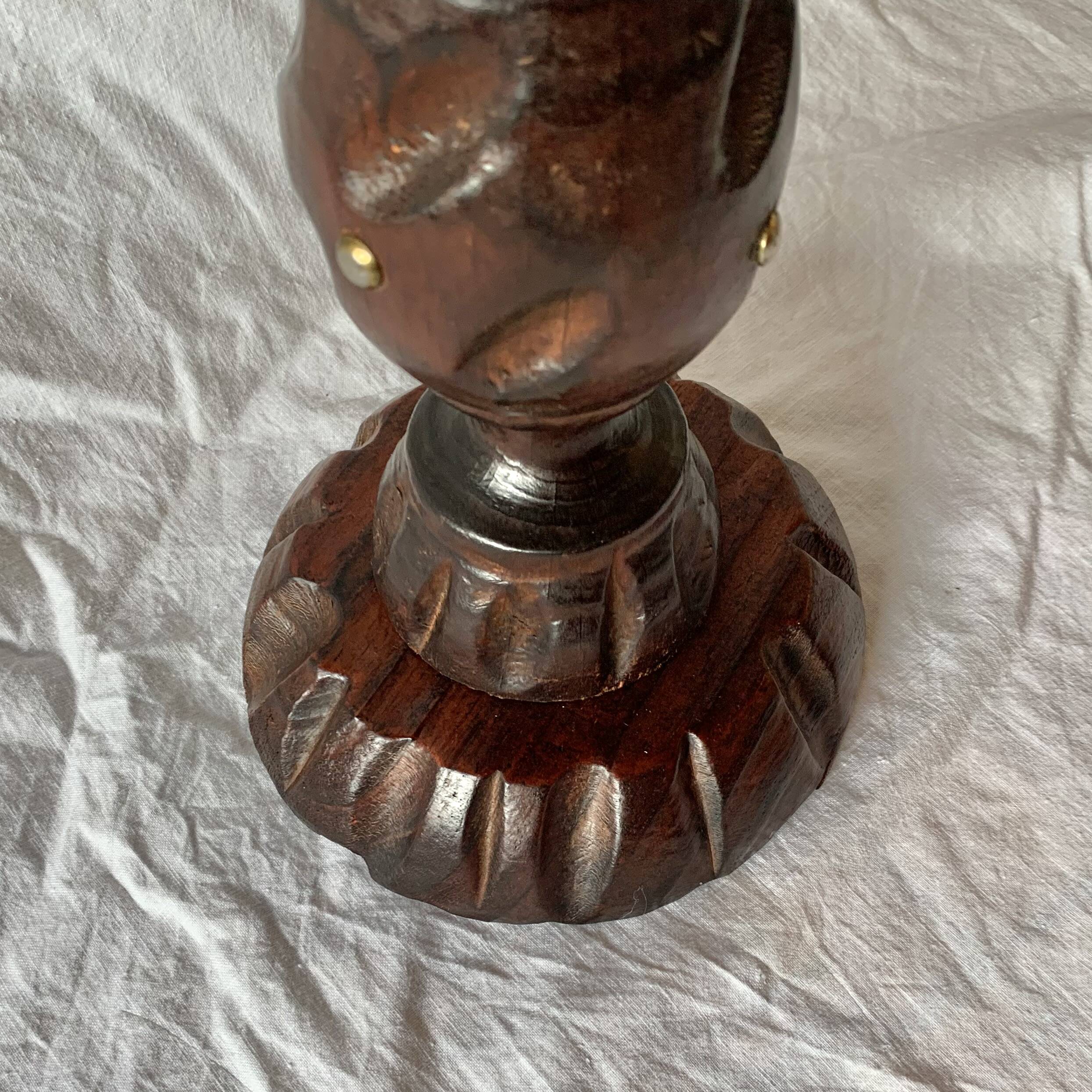 Old ashtray on carved wooden stand