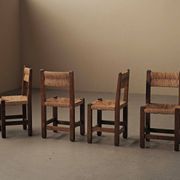 Set of four modernist chairs in oak and straw, France, circa 1960.