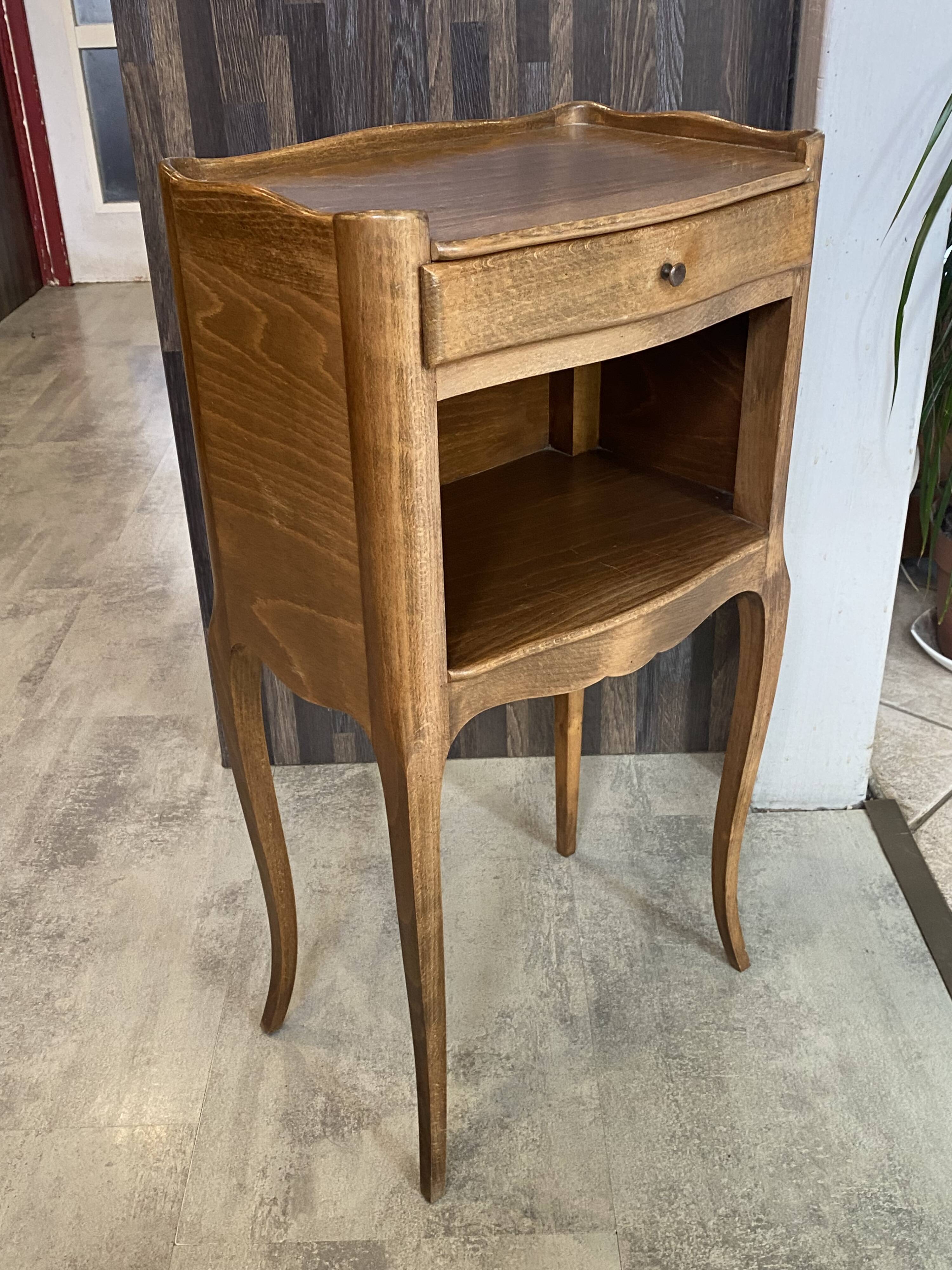 A bedside table with a drawer and a niche in Louis XV style.