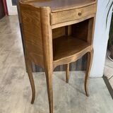 A bedside table with a drawer and a niche in Louis XV style.