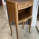 A bedside table with a drawer and a niche in Louis XV style.