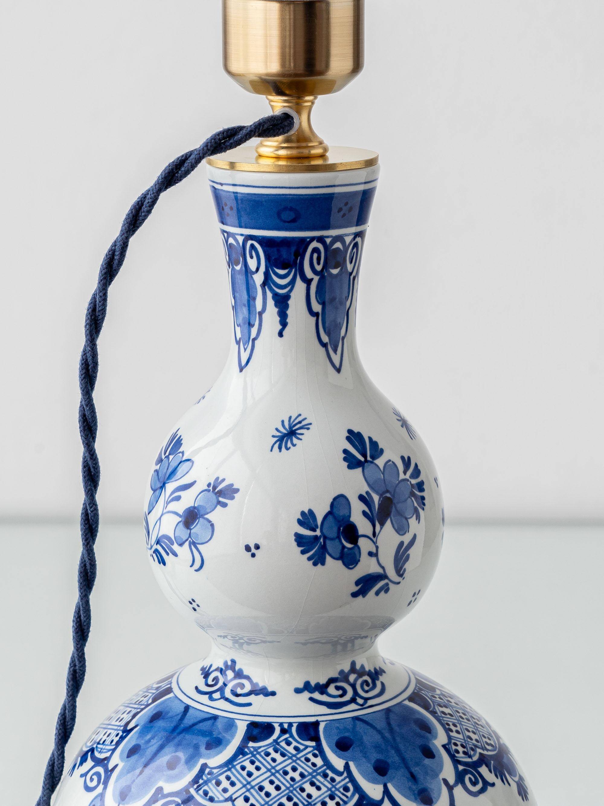 Pair of Royal Delft blue and white ceramic table lamps with new vermilion silk shades.