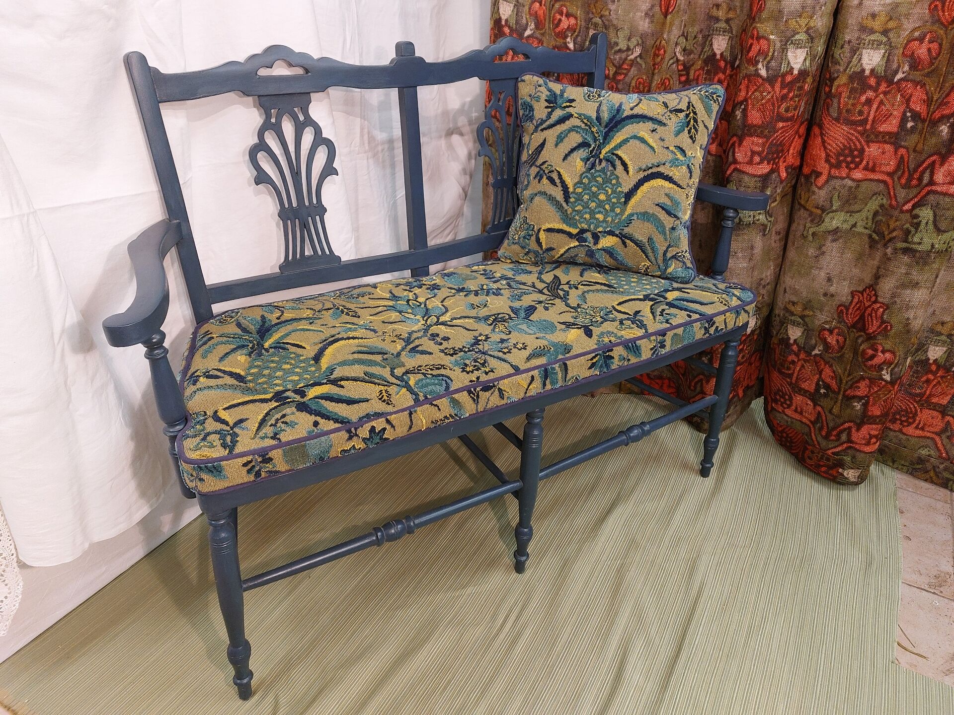 Pretty painted and upholstered bench in green and blue.