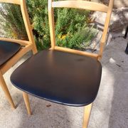 3 Scandinavian style chairs, light wood and black faux leather.