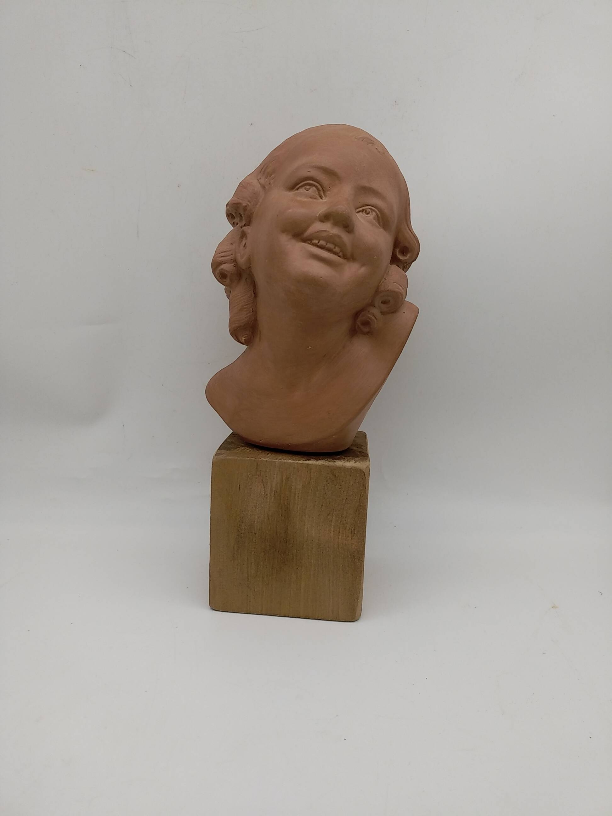 Bust young smiling girl. Circa 1900. Art Deco. Signed.