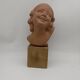 Bust young smiling girl. Circa 1900. Art Deco. Signed.