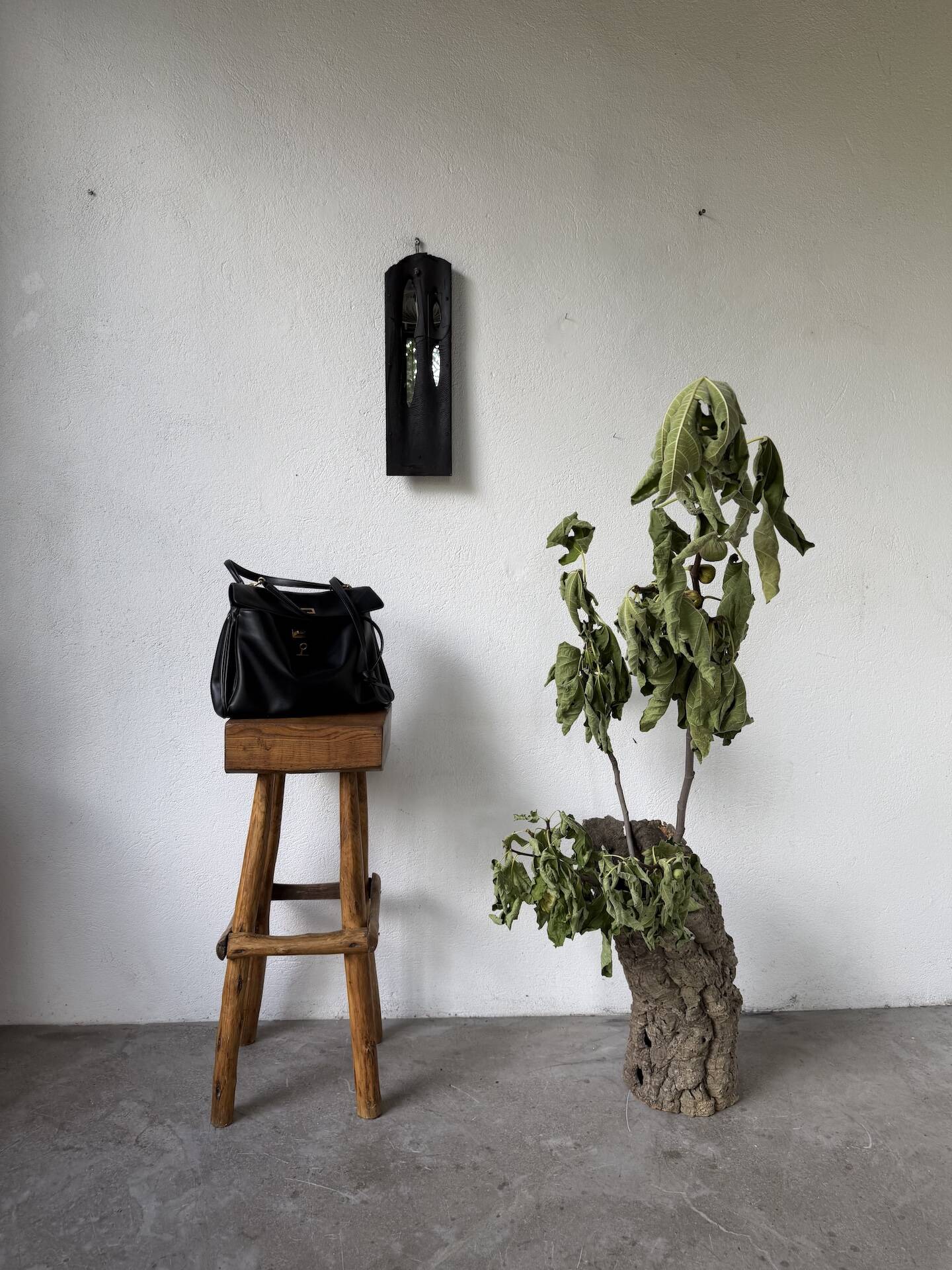 Brutalist hammered mirror, free-form, patinated metal.