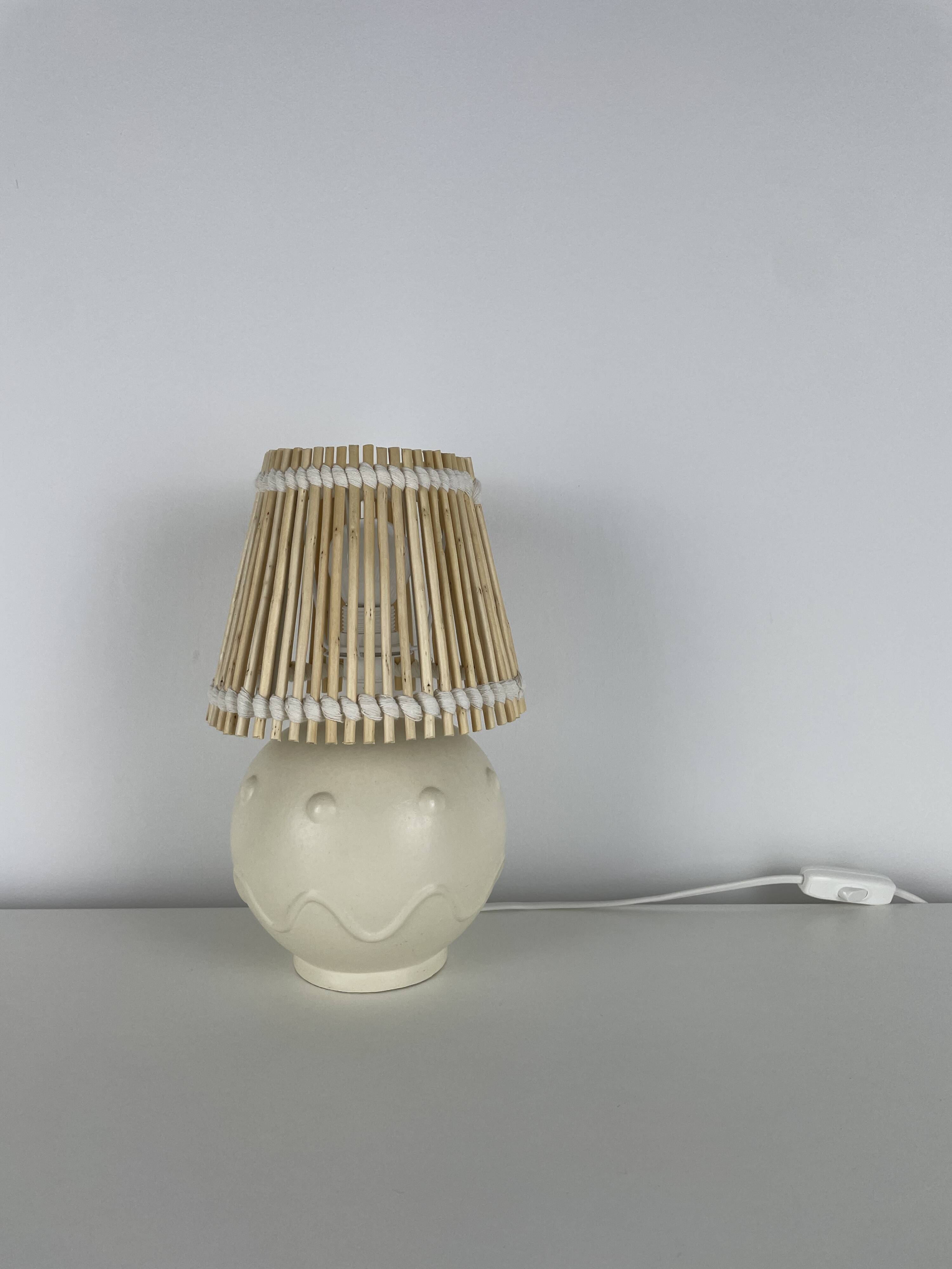 Vintage ceramic lamp with wicker and cotton shade.