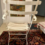 White armchair with wooden slats and metal structure