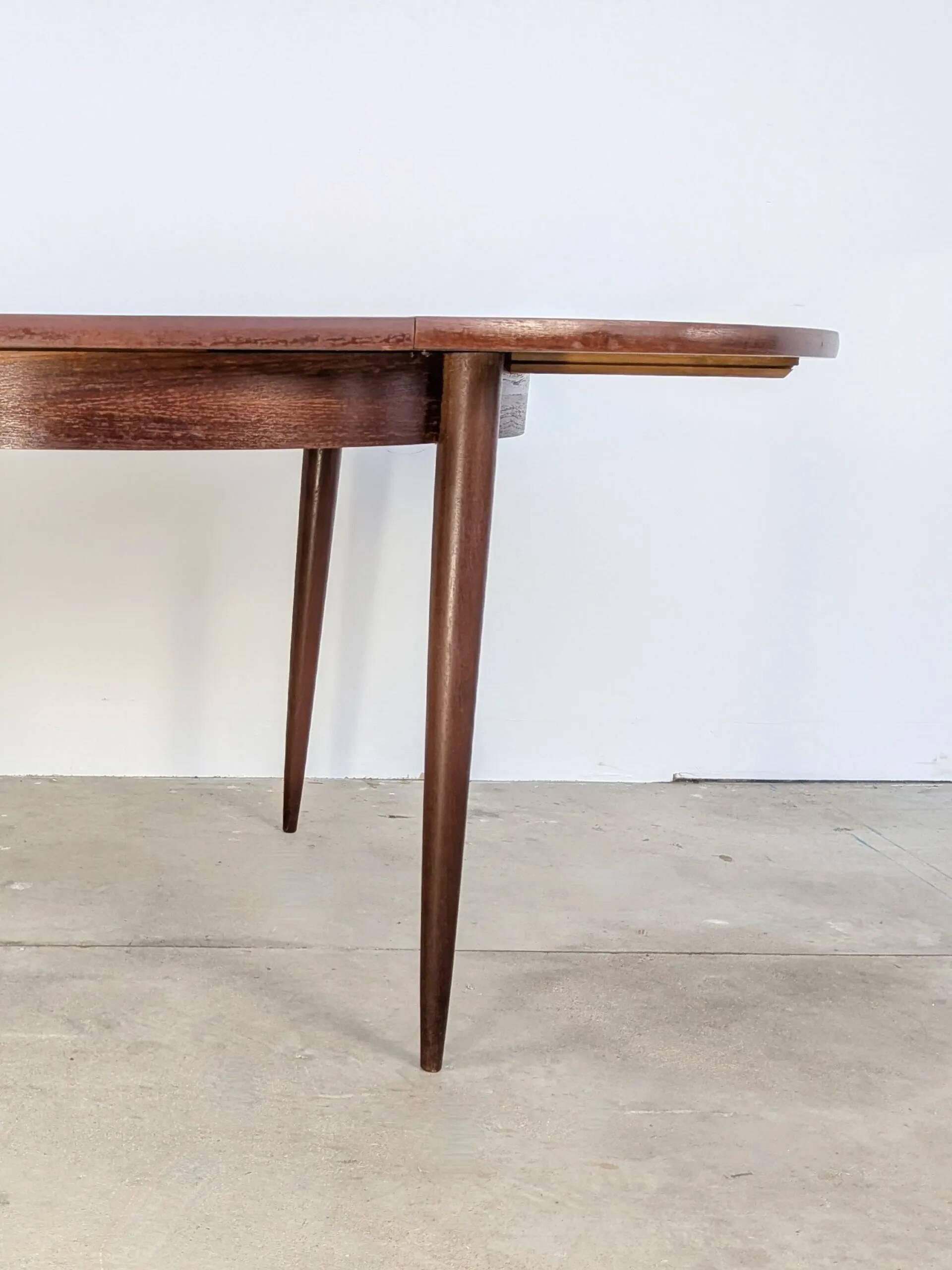 Round extendable wooden dining table