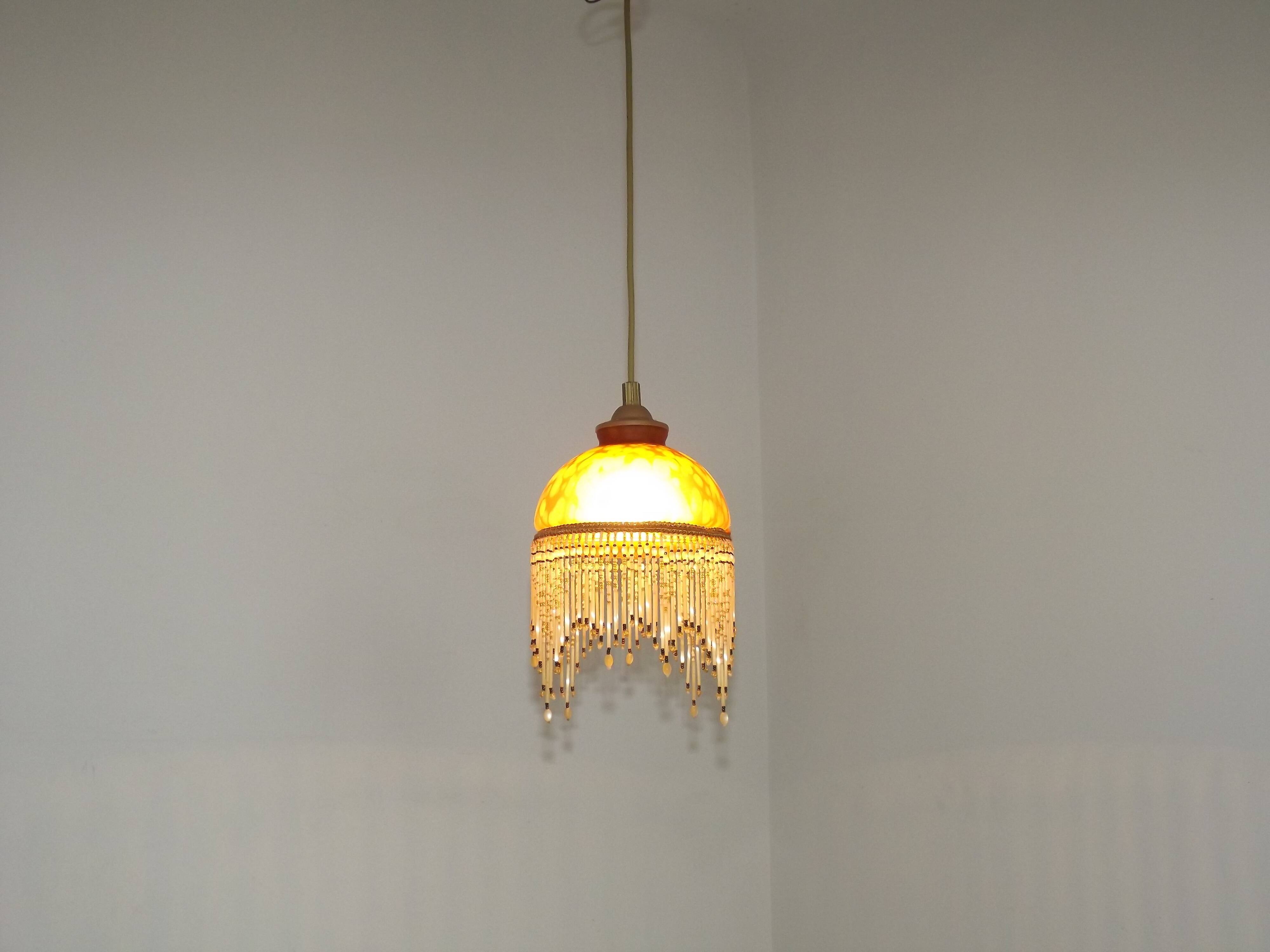 Vintage French amber mottled glass hanging ceiling light with beaded fringe.