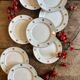 Set of 10 vintage white and gold dessert plates.