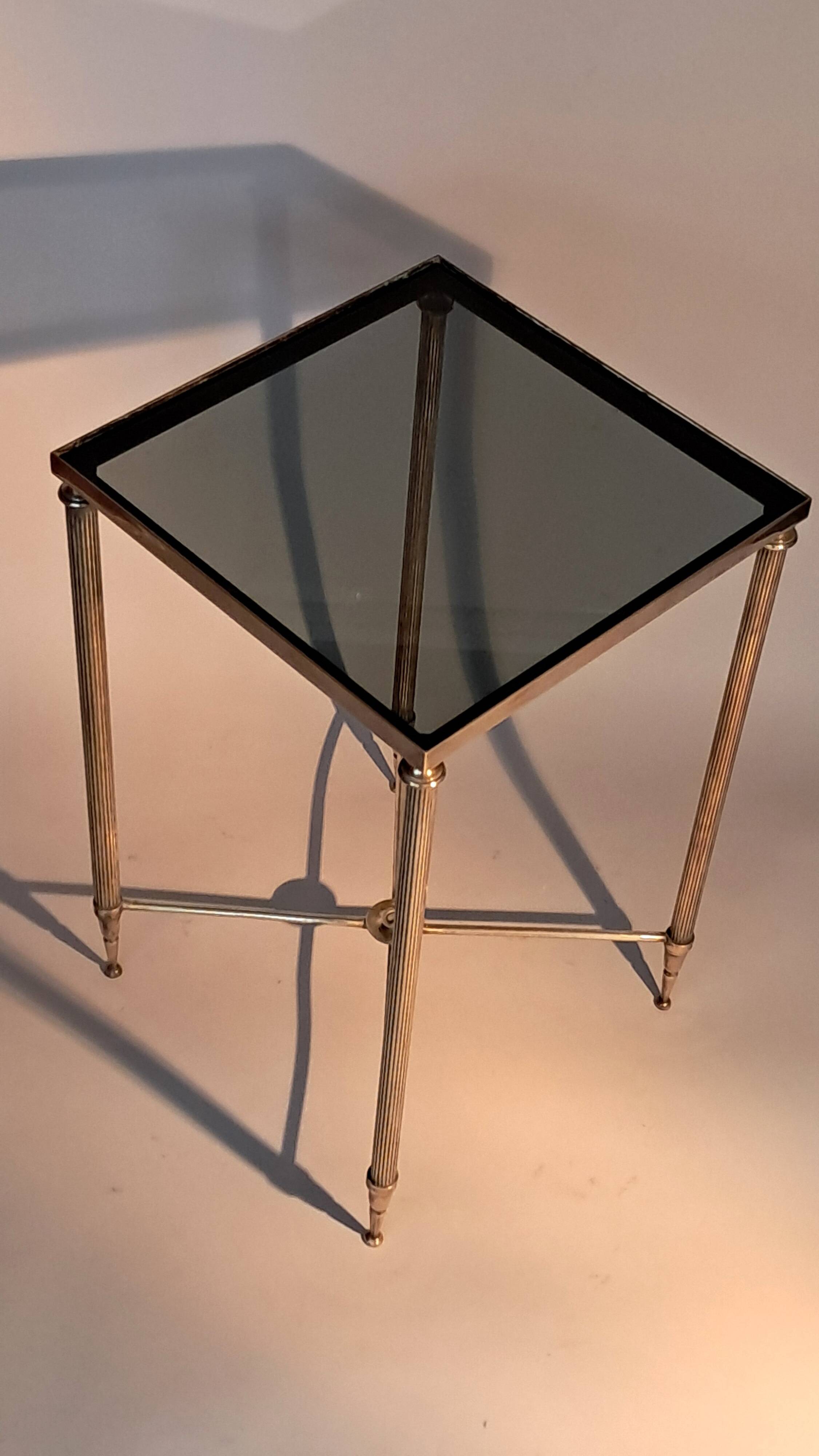 Gold brass side table in neoclassical style, circa 1960.