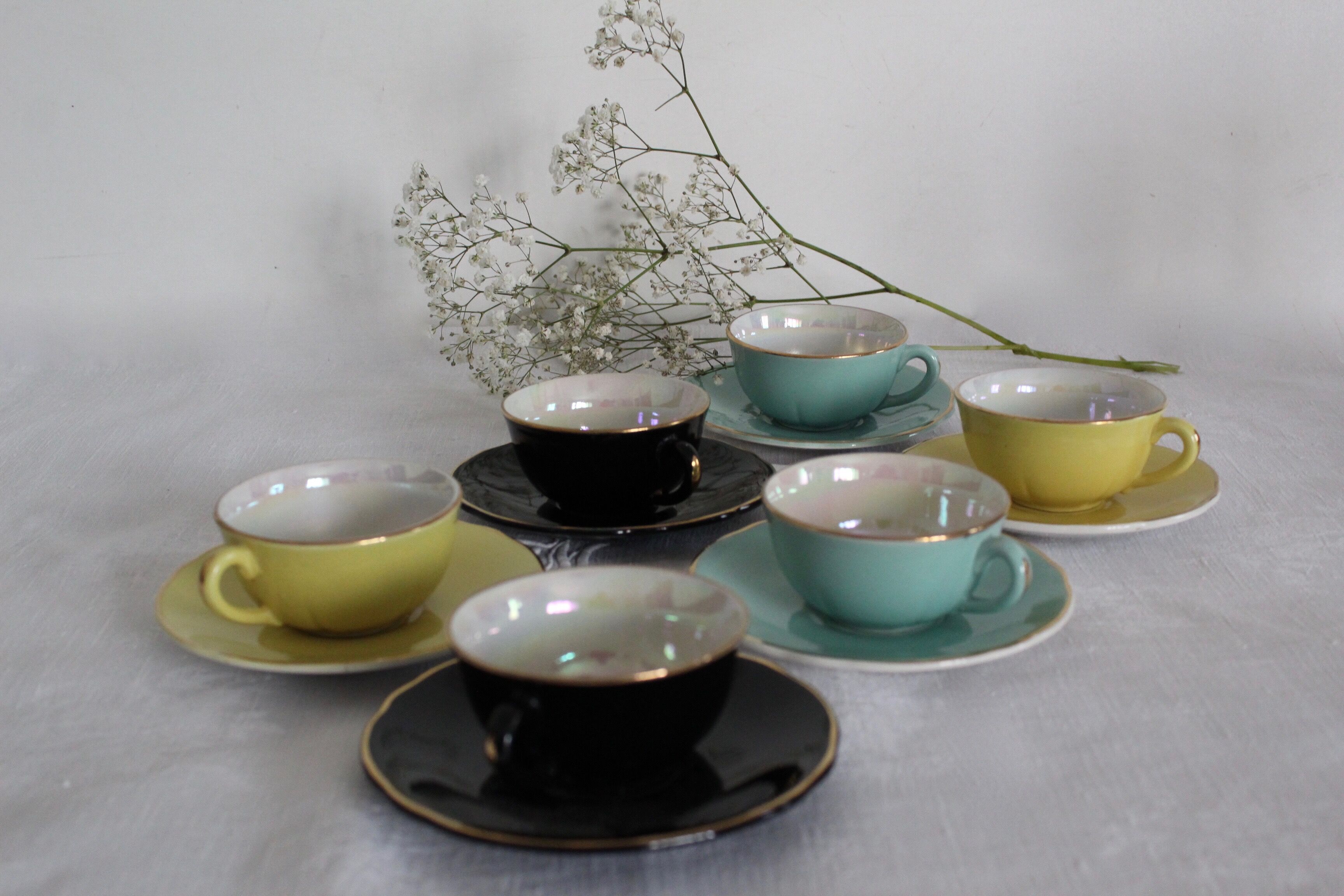 6 multicolored cups and saucers, pearly interior