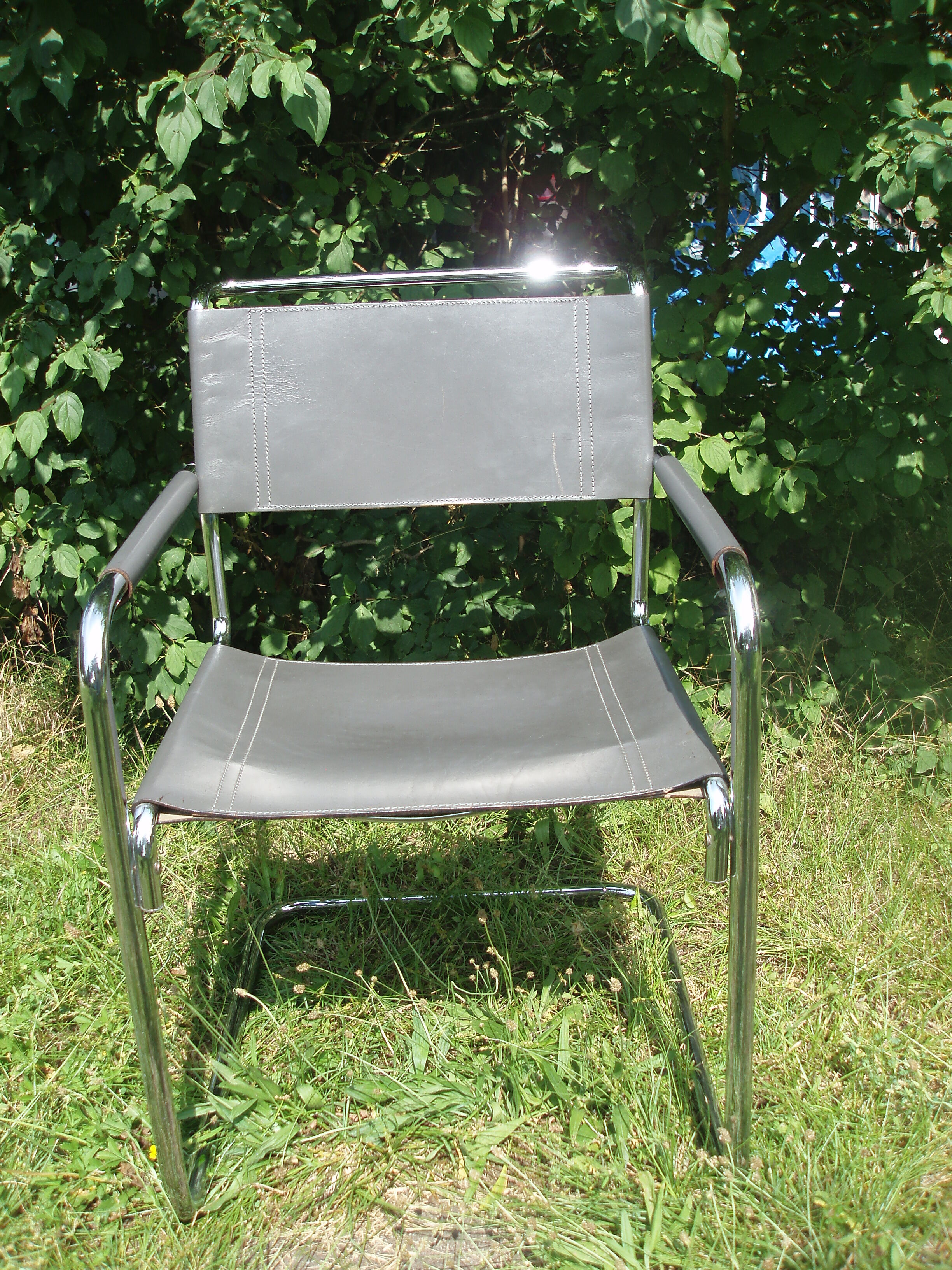 Series of grey and chrome leather armchairs