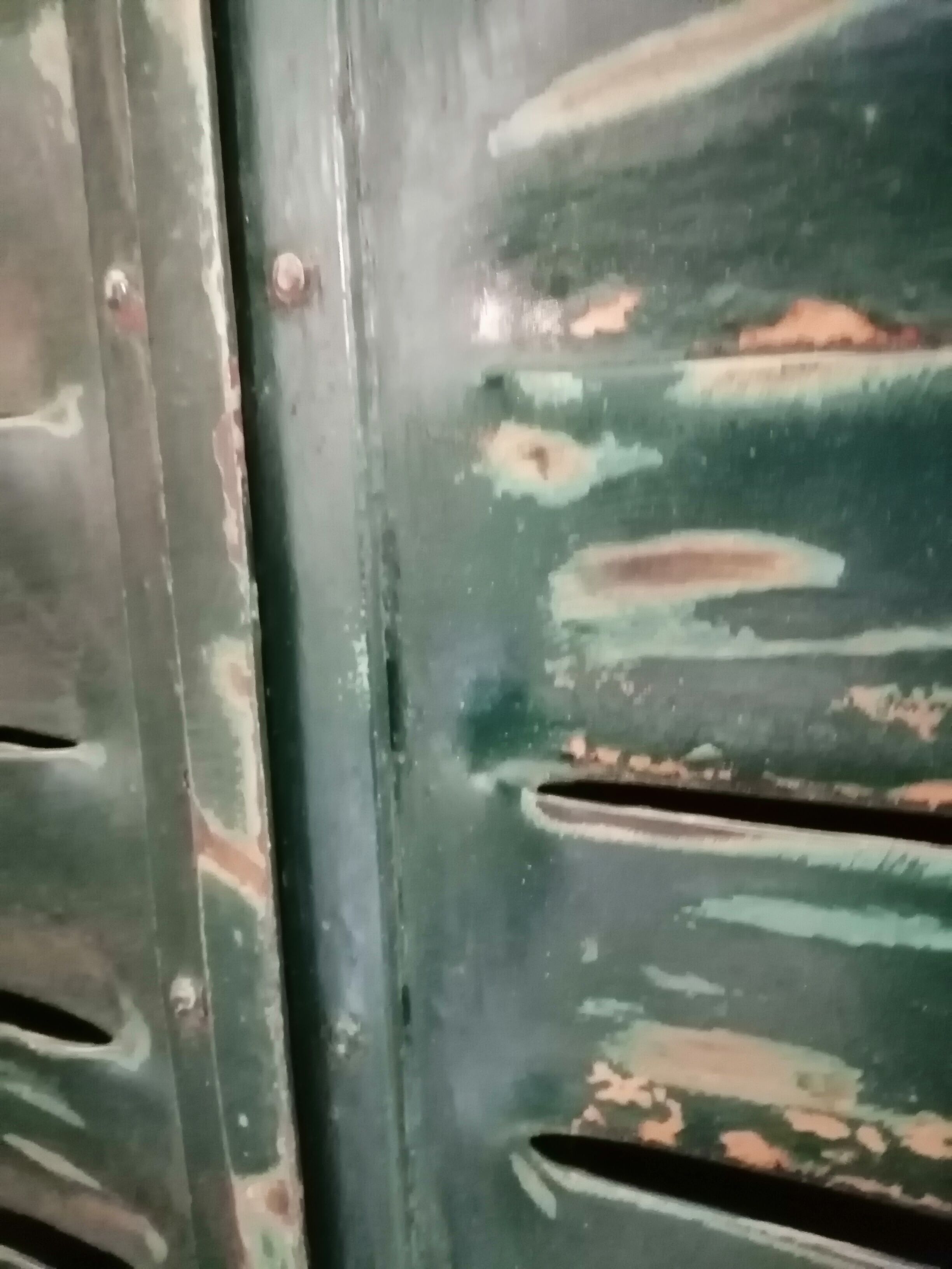 Lot of old green shutters in 4-part iron screen headboard