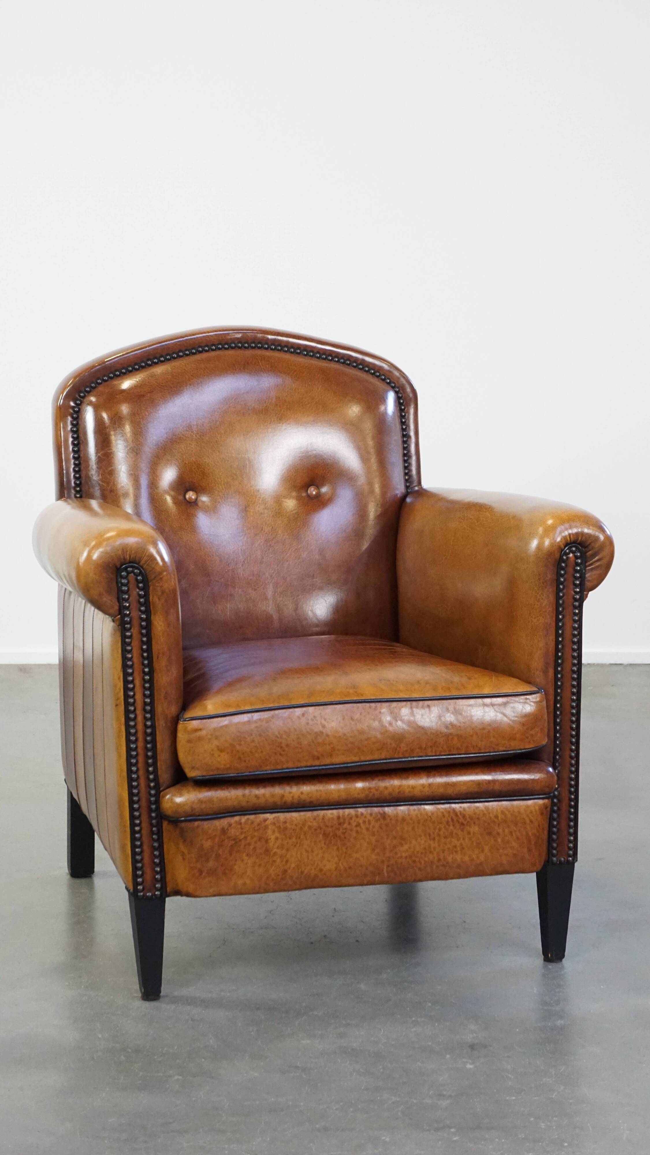 Sheep leather design armchair finished with decorative nails and black piping
