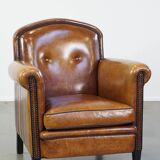 Sheep leather design armchair finished with decorative nails and black piping