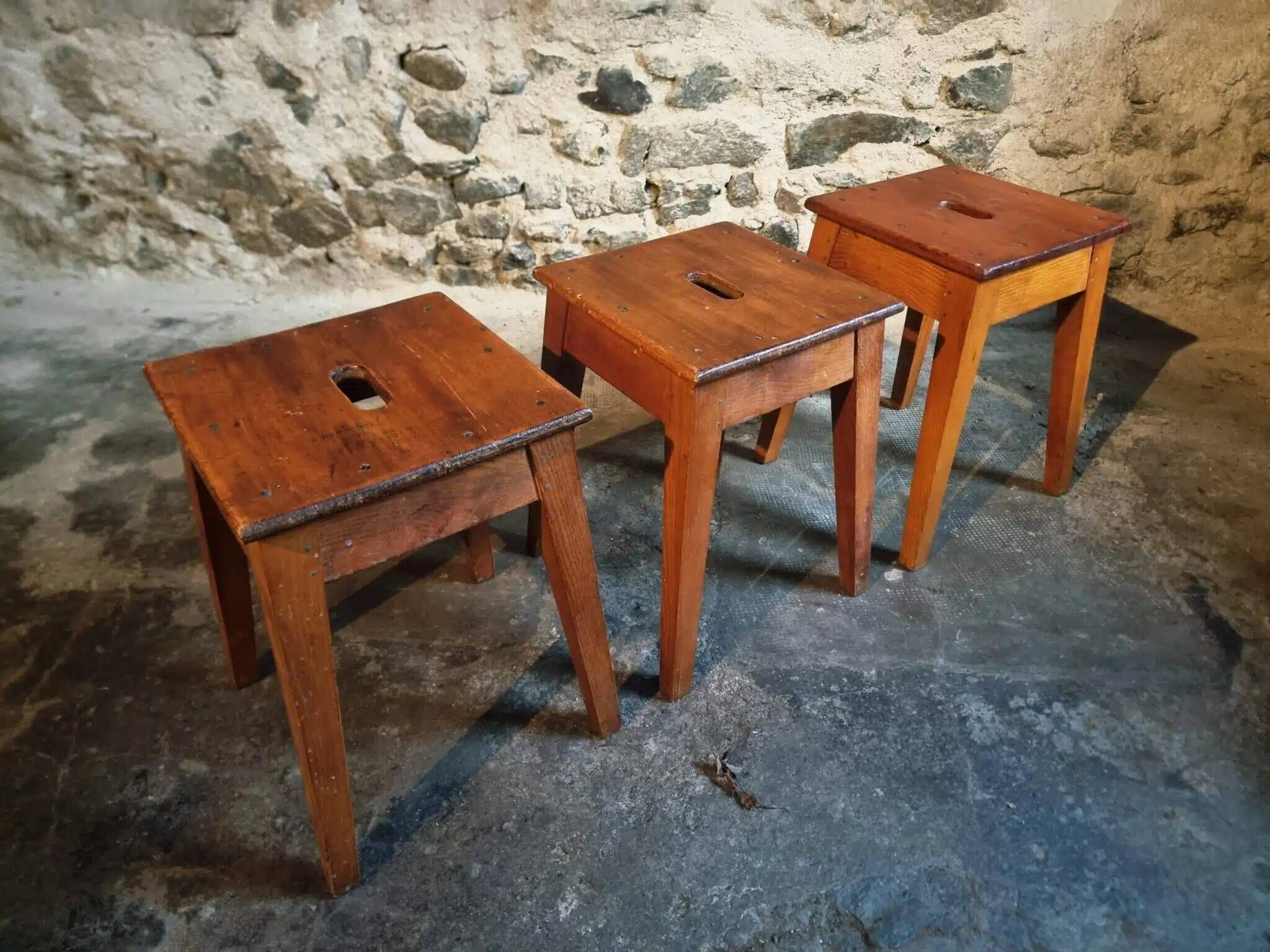 Set of 3 vintage French wooden stools from the 1950s.