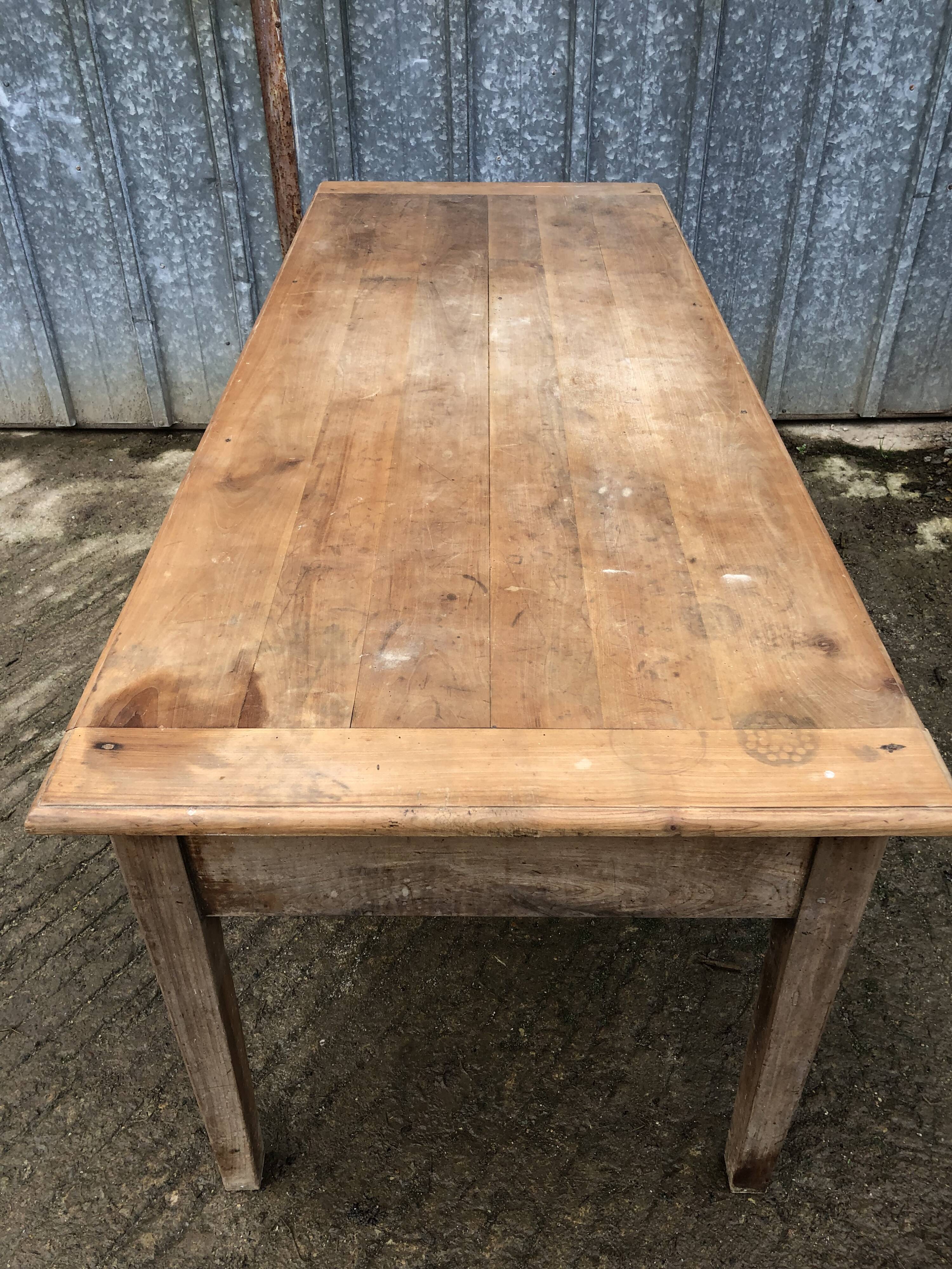 Antique solid cherry farm table with 3 front drawers.