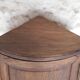 Antique wooden corner cabinet with a curved door.