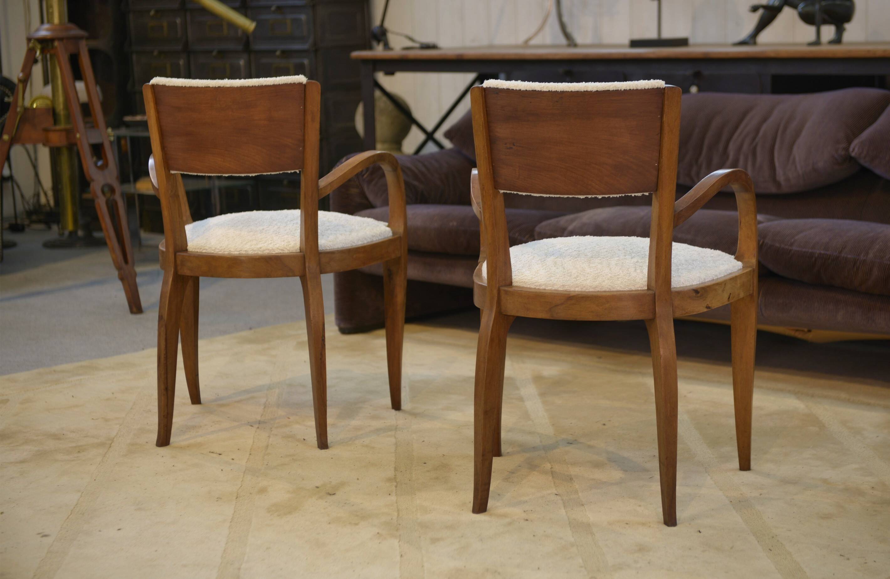 Pair of bridge armchairs in walnut and cream boucle fabric, early 20th century.
