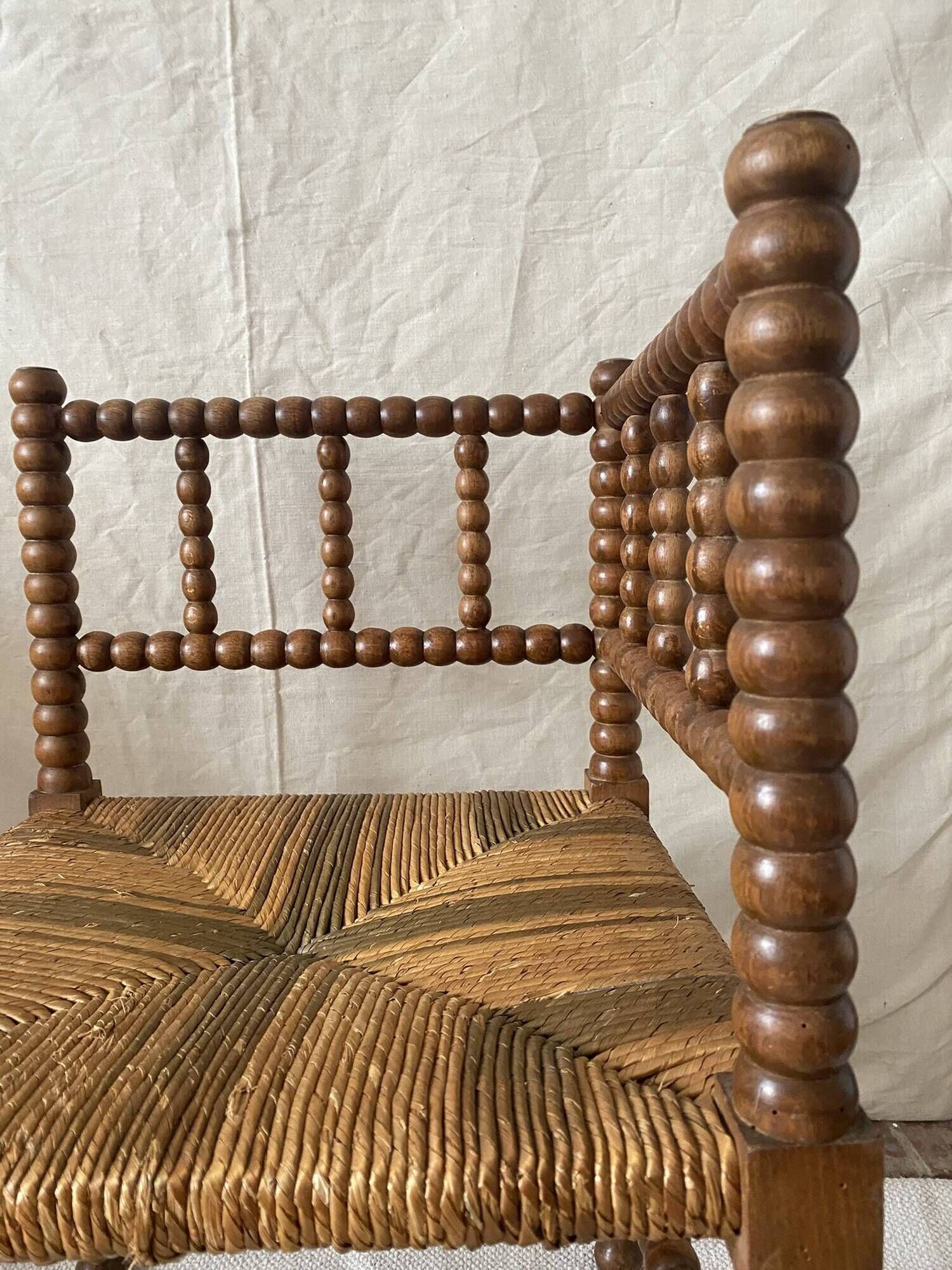 Corner chair in straw and turned wood, fireside chair.