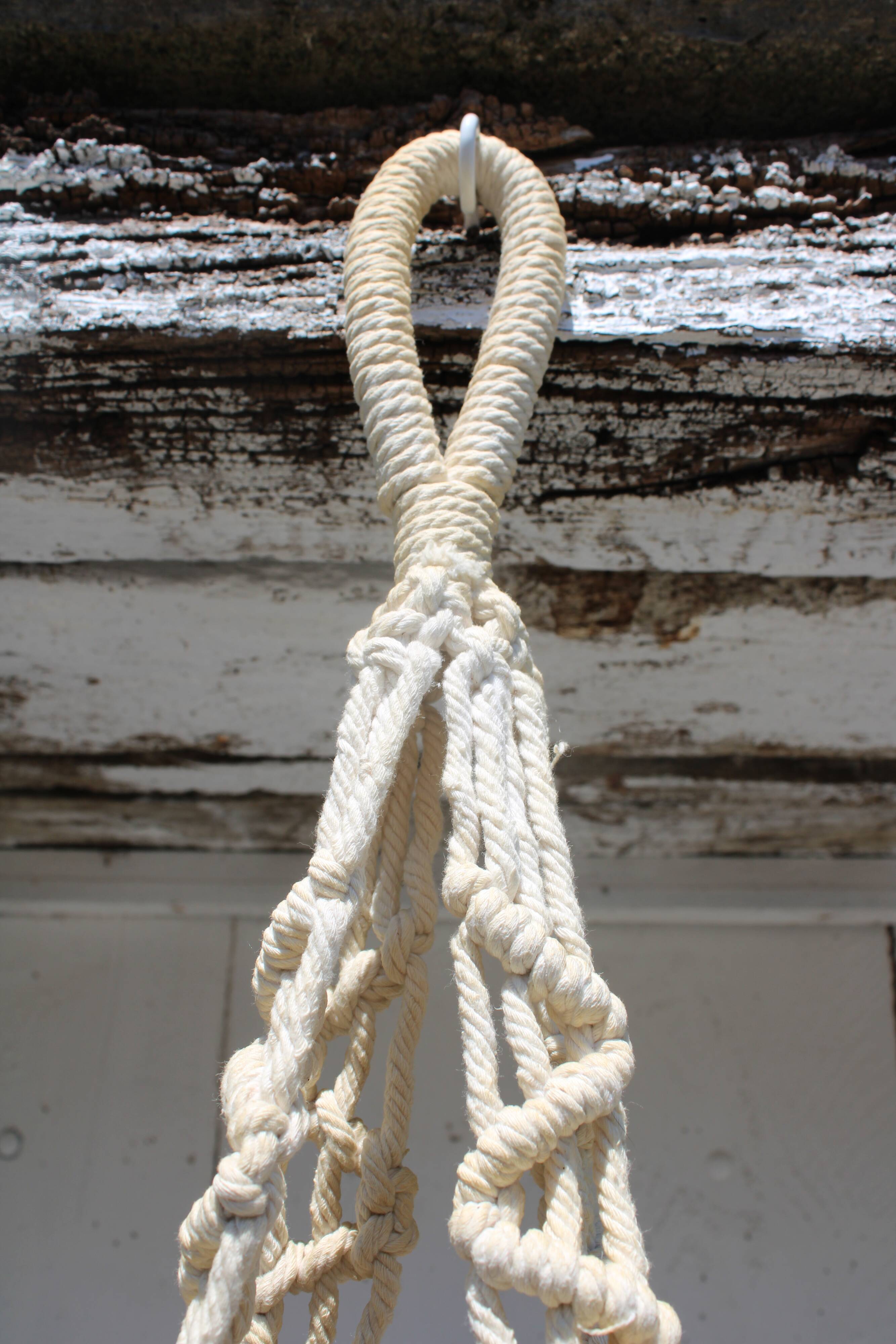 Hanging plant holders in macramé and rattan