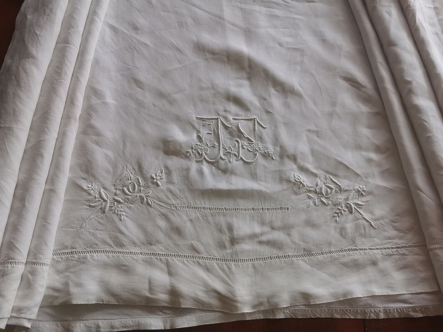 Antique embroidered linen sheet with a monogram.