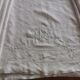 Antique embroidered linen sheet with a monogram.