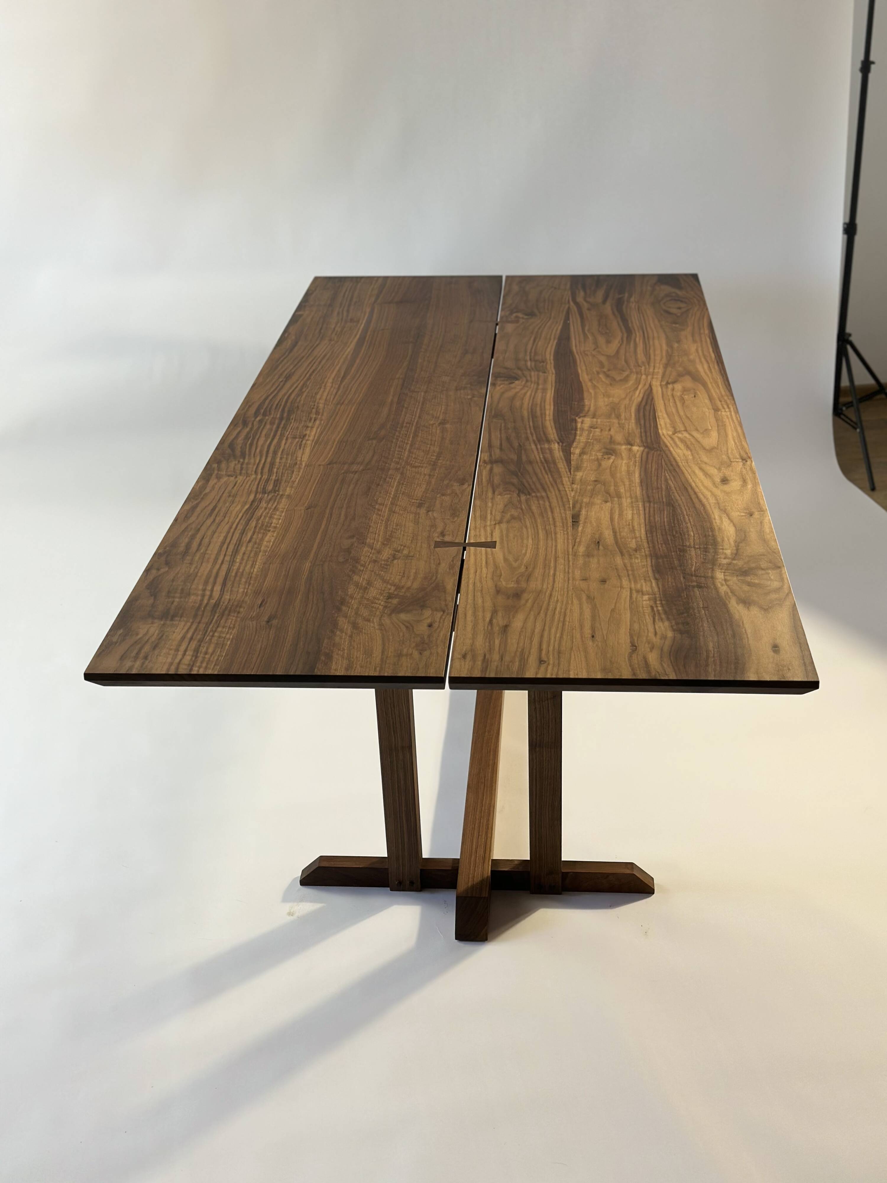 Exceptional dining table in solid walnut.