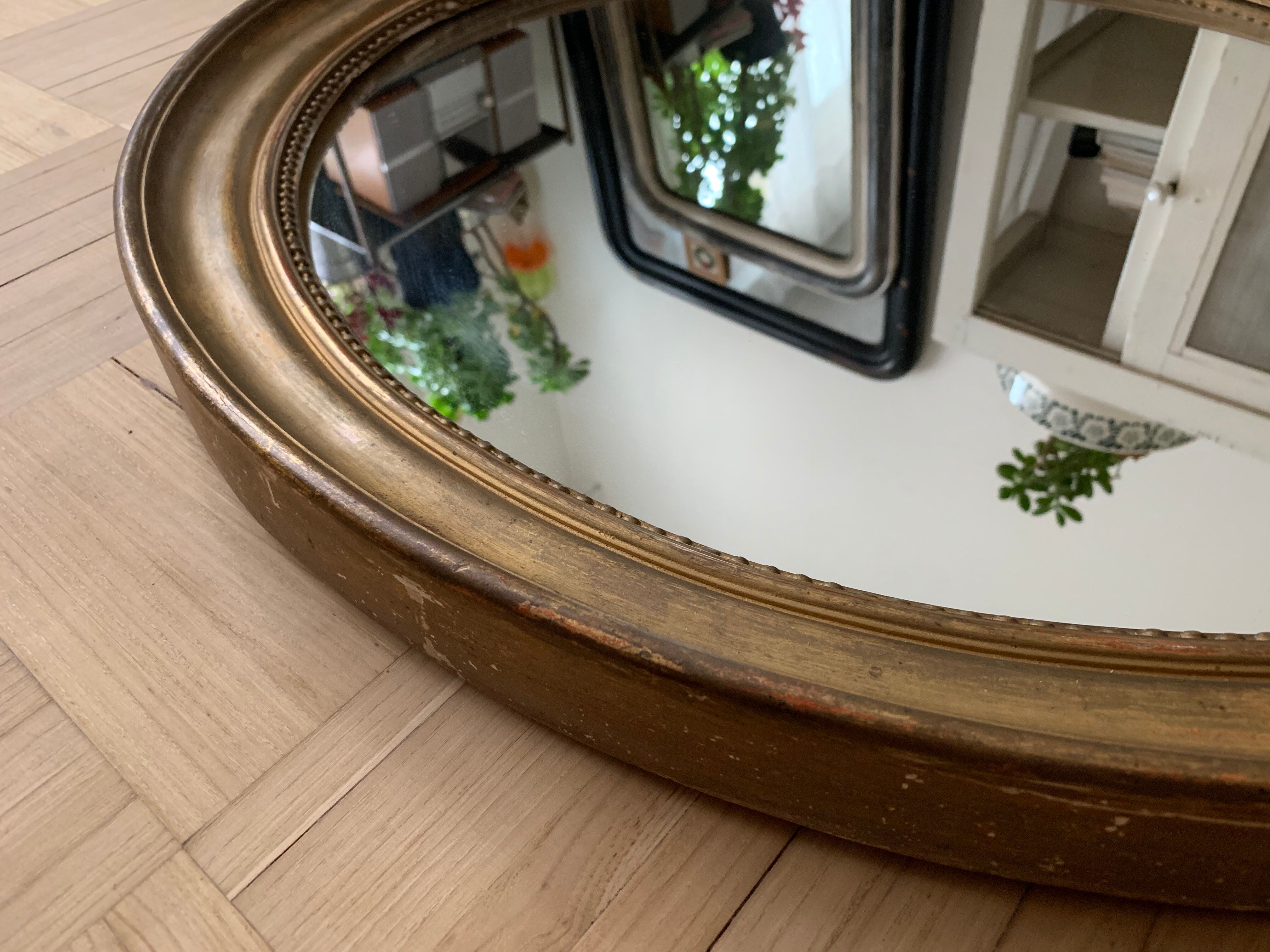 Old oval golden mirror
