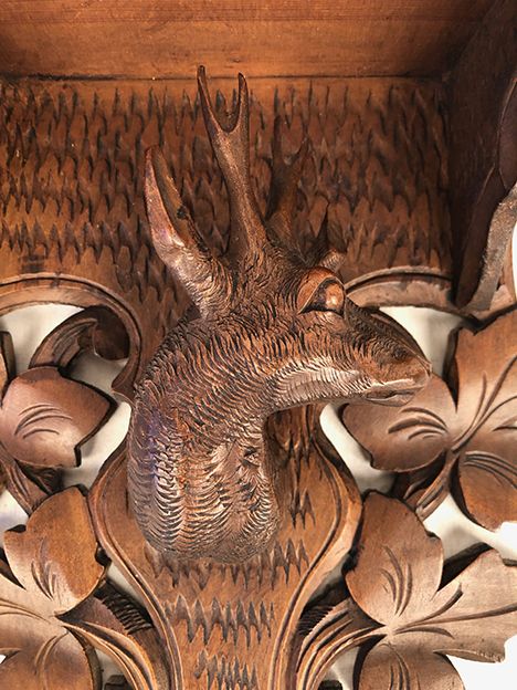 Pair of carved wooden wall consoles decorated with a deer's head
