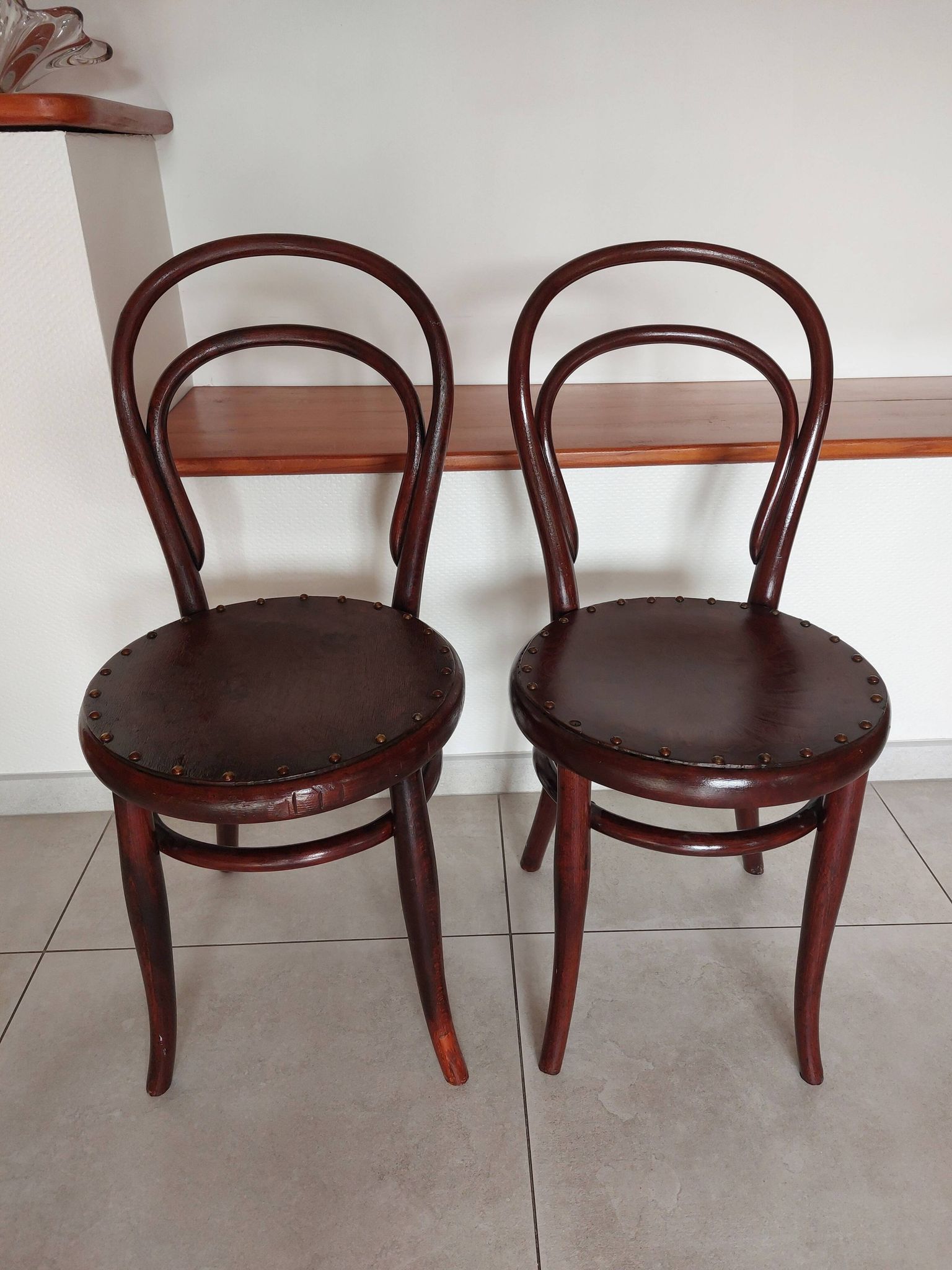 pair of round bistro chairs with a pattern on the seat, vintage