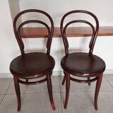 pair of round bistro chairs with a pattern on the seat, vintage